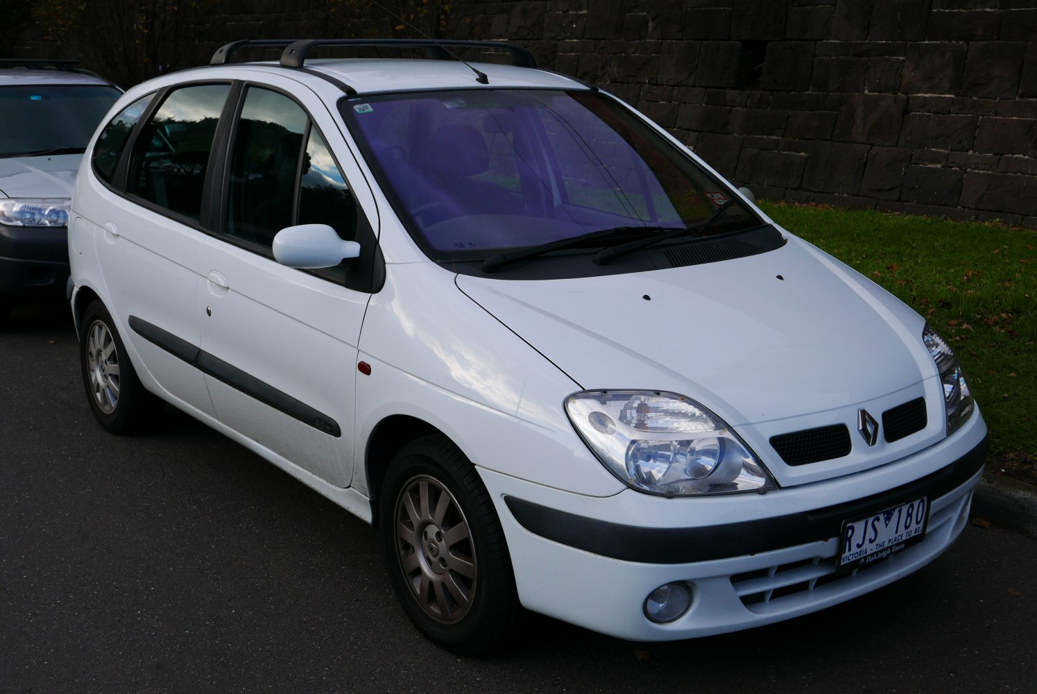 Front side view with headlights and distinctive grille.