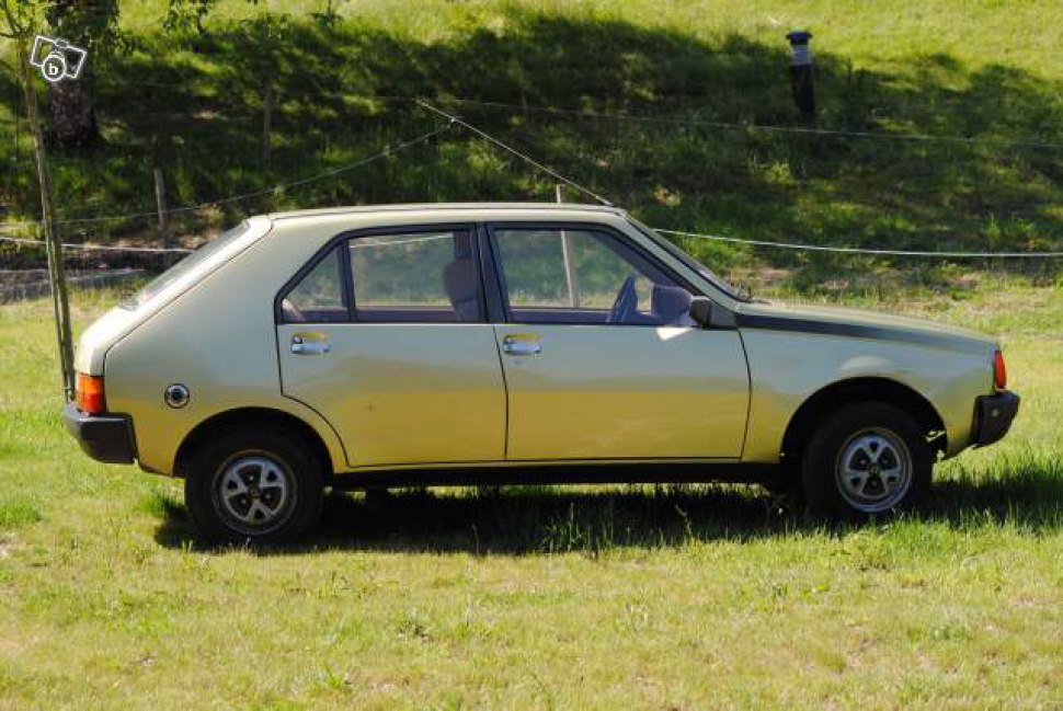Classic hatchback side profile with distinct door handles and compact design