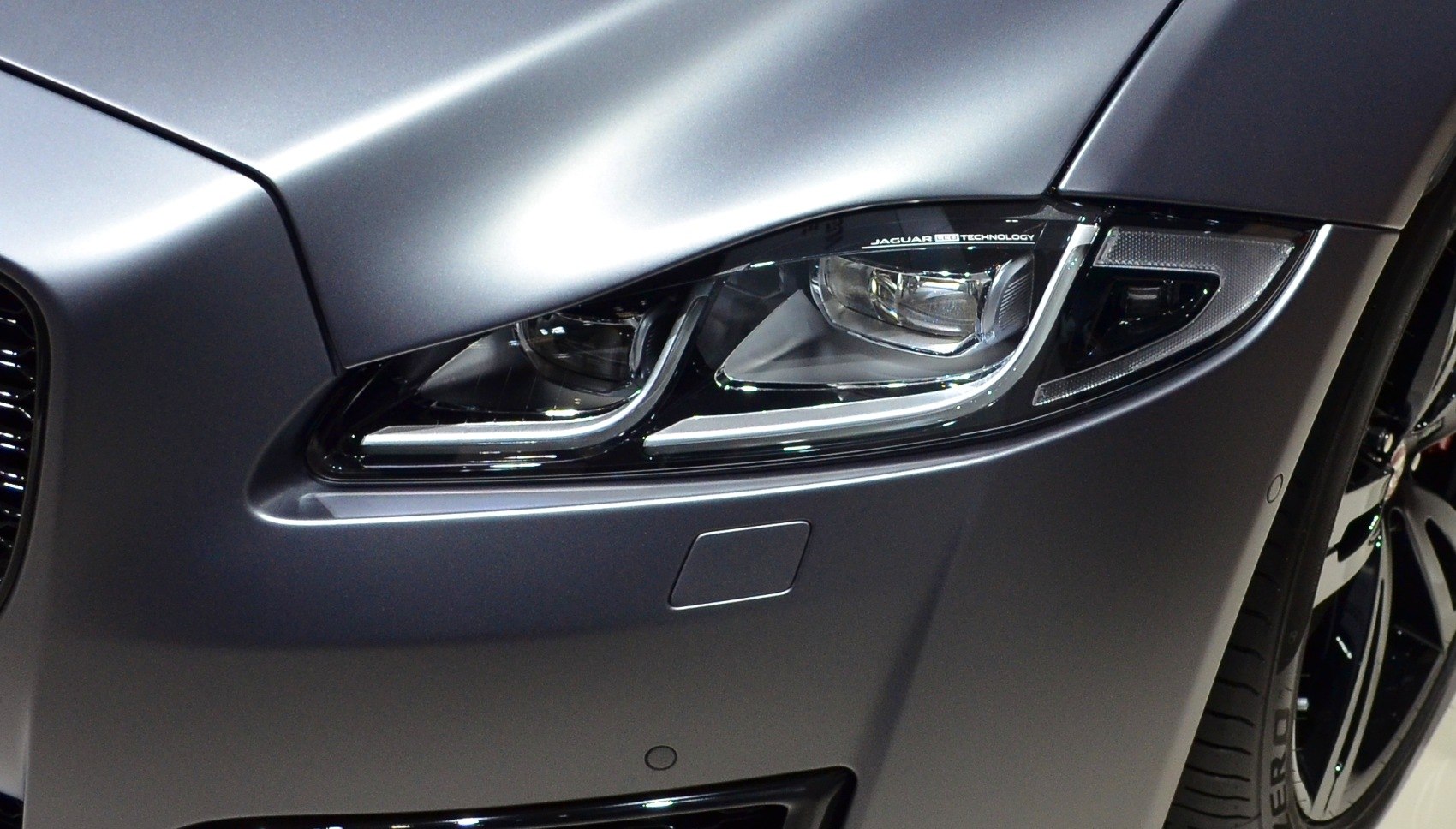 Close-up of a sleek LED headlight and front bumper detail.