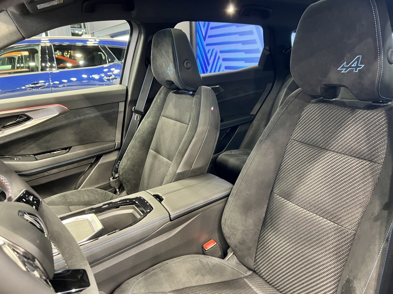 Premium alcantara front seats with embroidered headrests and detailed stitching