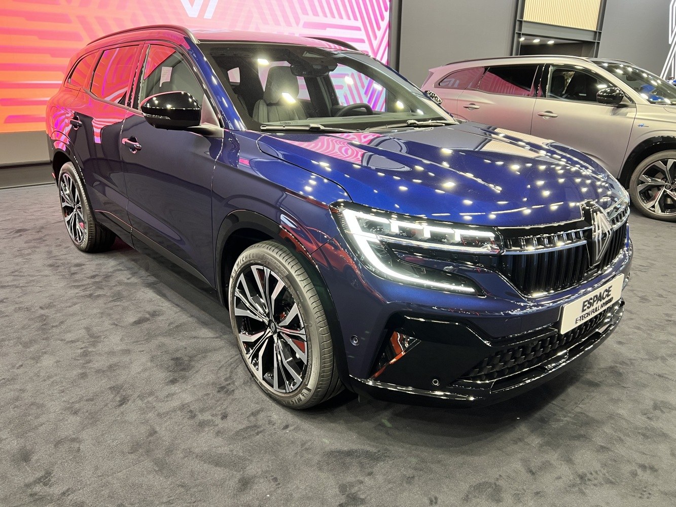 Sharp LED headlights and multi-spoke alloy wheels on an SUV front side.