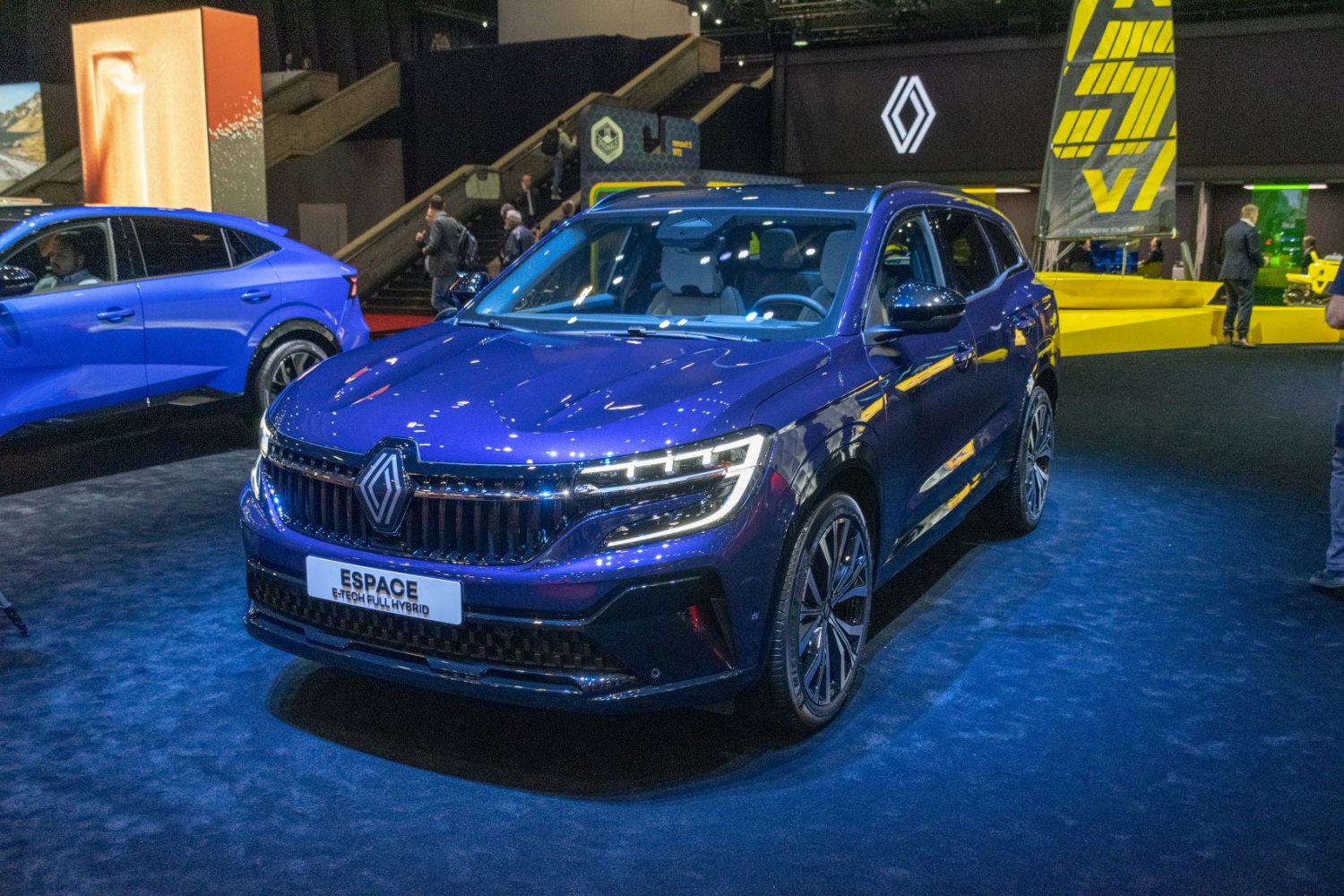 Modern hybrid SUV front with LED headlights and bold grille in blue.