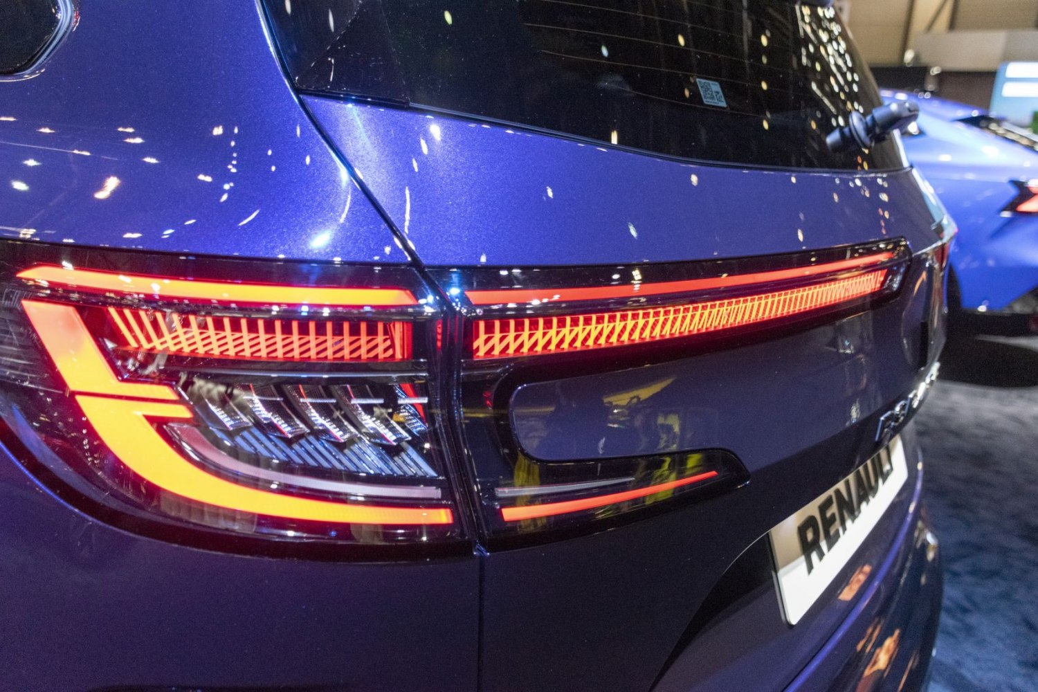Modern tail light and rear window detail of a vehicle.