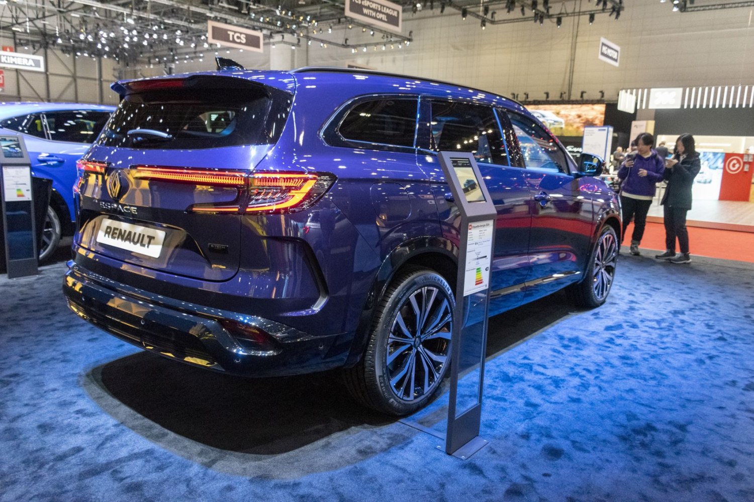 Blue modern SUV rear with continuous LED taillights and roof spoiler