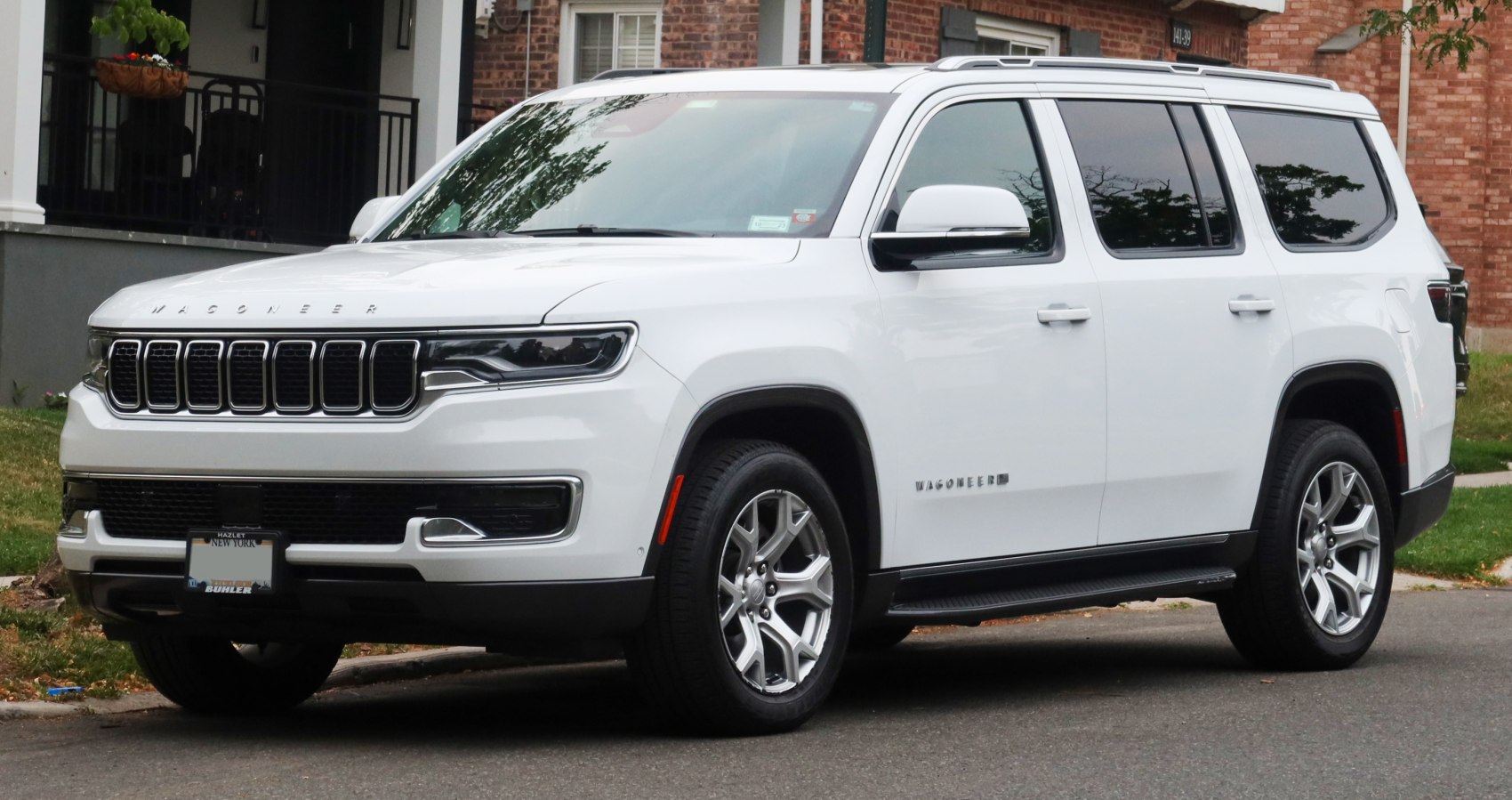 White large SUV with seven-slot grille and sleek LED headlights side view