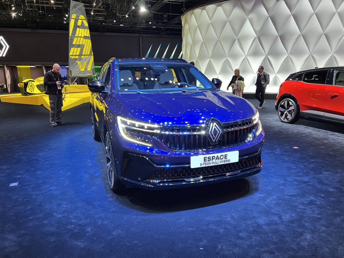Front view of blue hybrid SUV with LED headlights and prominent grille