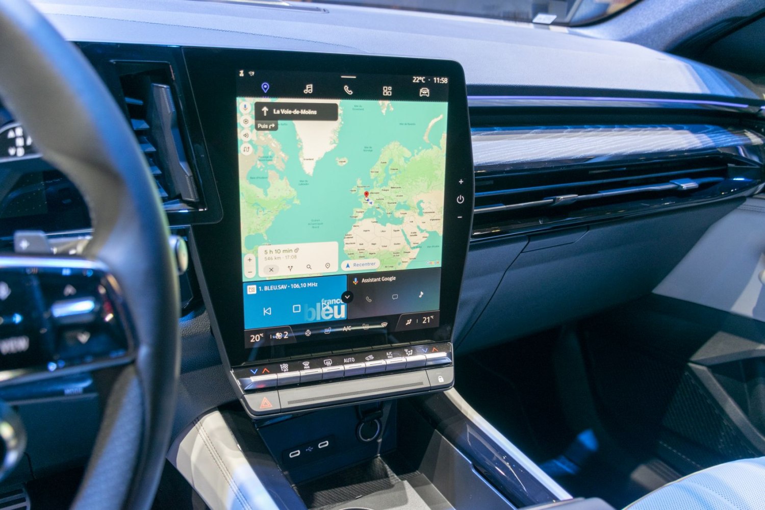 Large vertical touchscreen infotainment with map navigation and climate controls