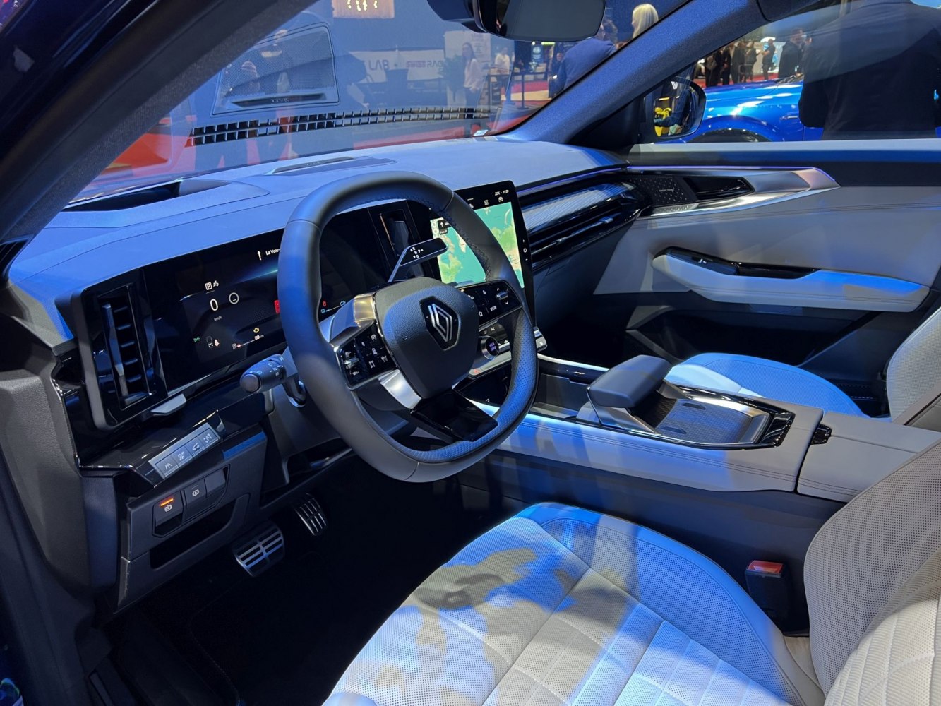 Modern digital dashboard and touchscreen interior with luxury seating.