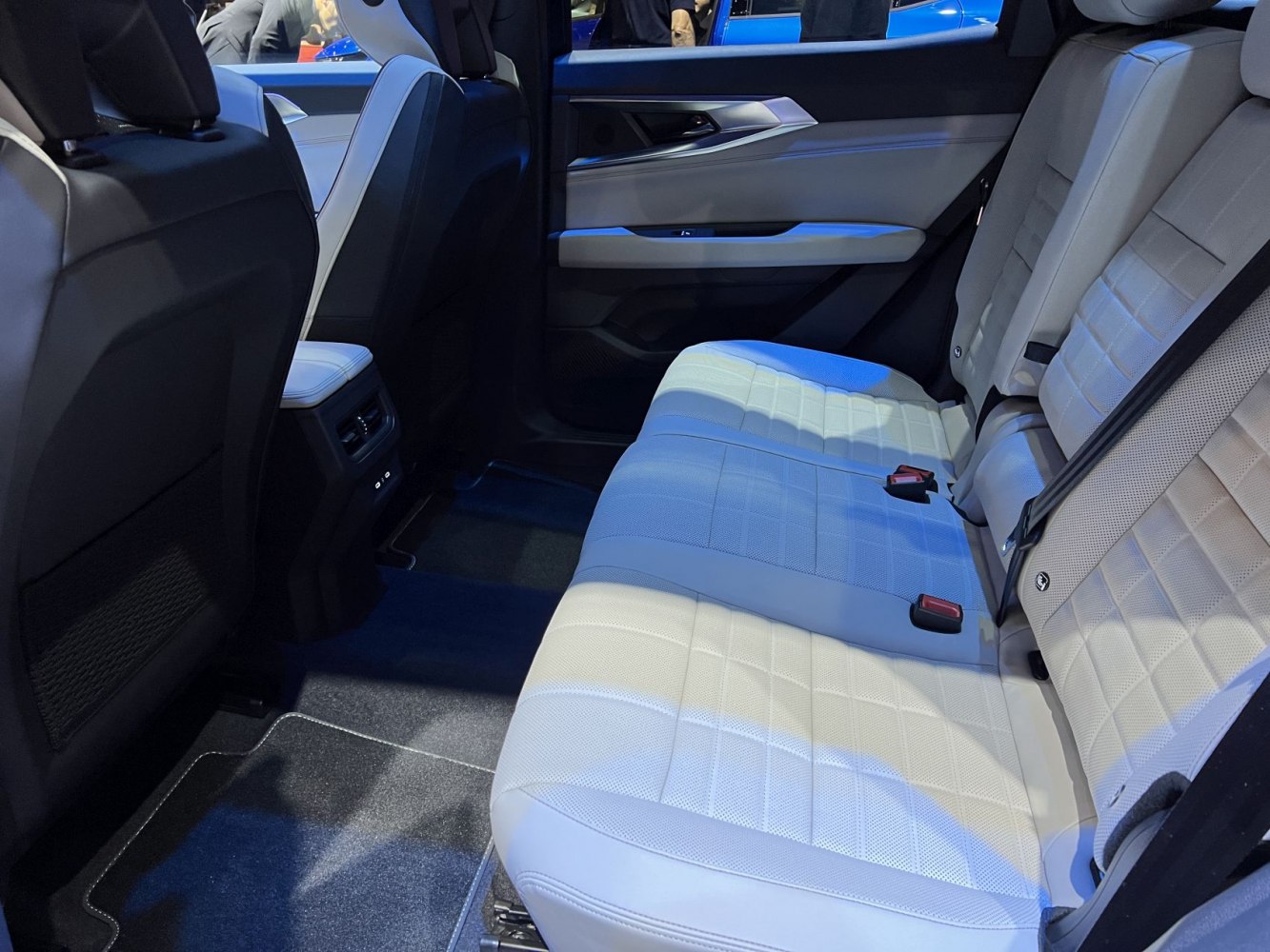 Spacious and premium rear seating interior with light upholstery and modern design