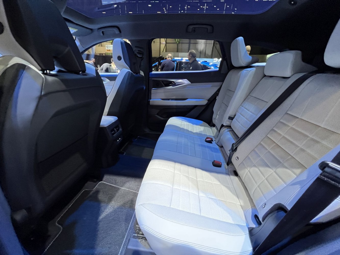Spacious rear seats with white upholstery and modern interior design