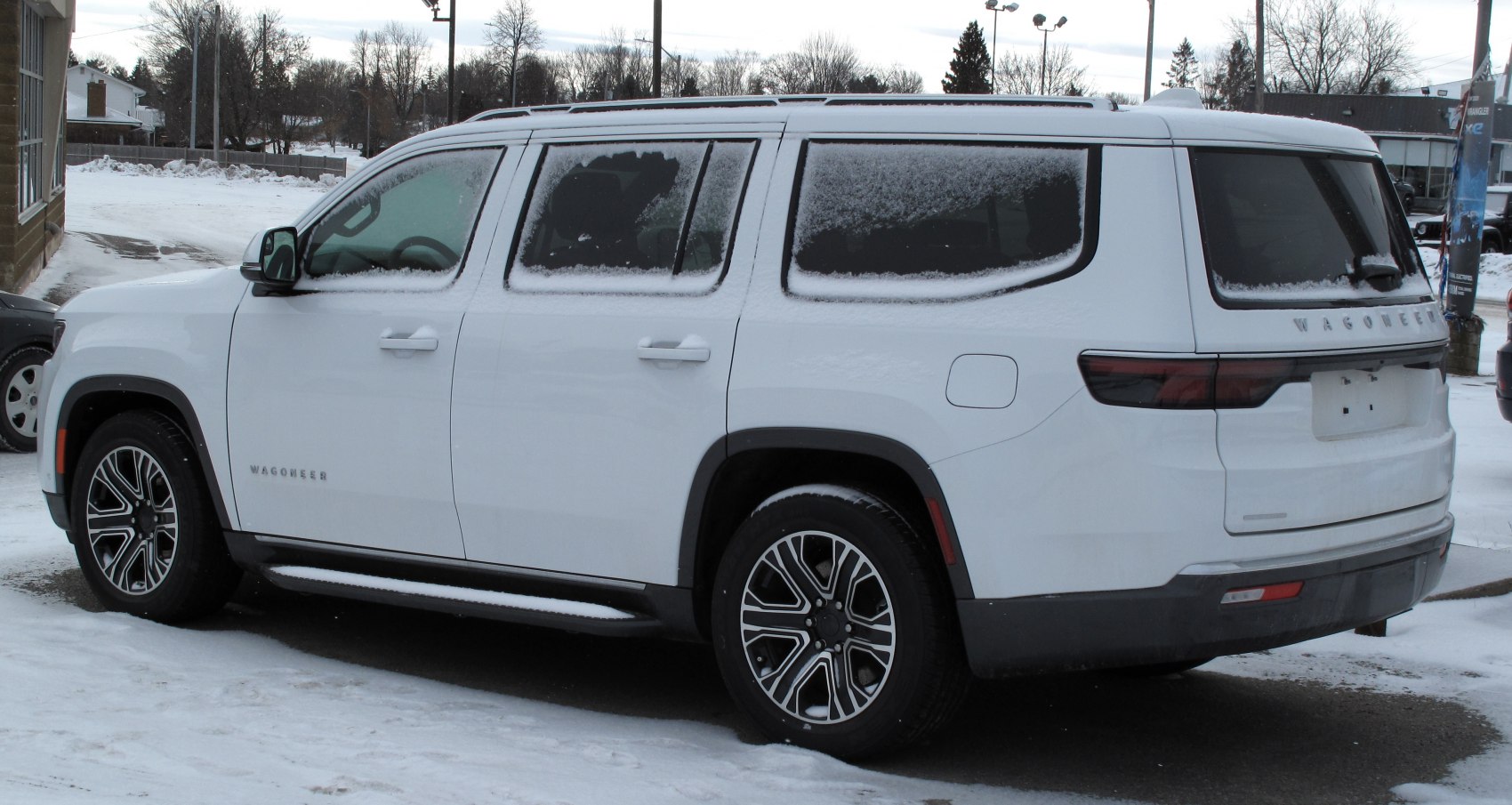 Large luxury SUV with boxy shape and snow-covered windows.