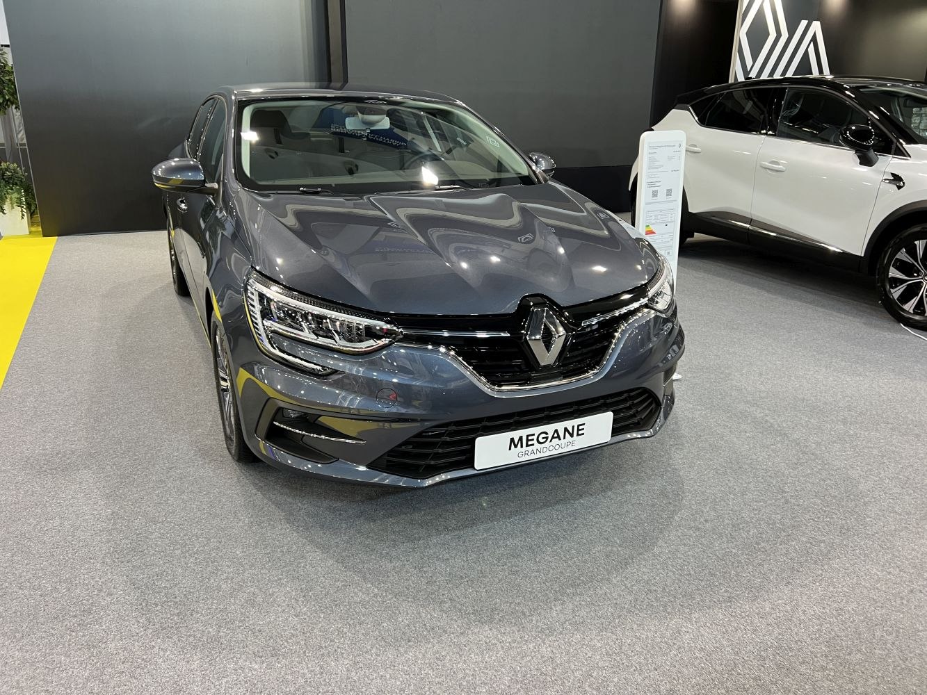 Front view of sedan with LED headlights and sleek grille