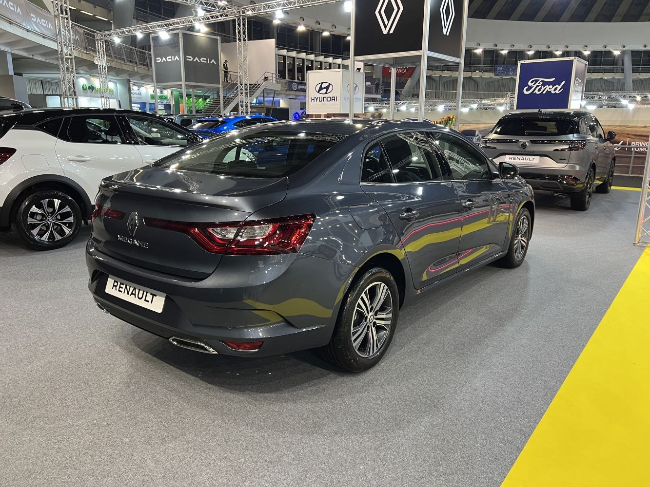 Rear view of a modern sedan with dynamic rear lights and smooth body lines