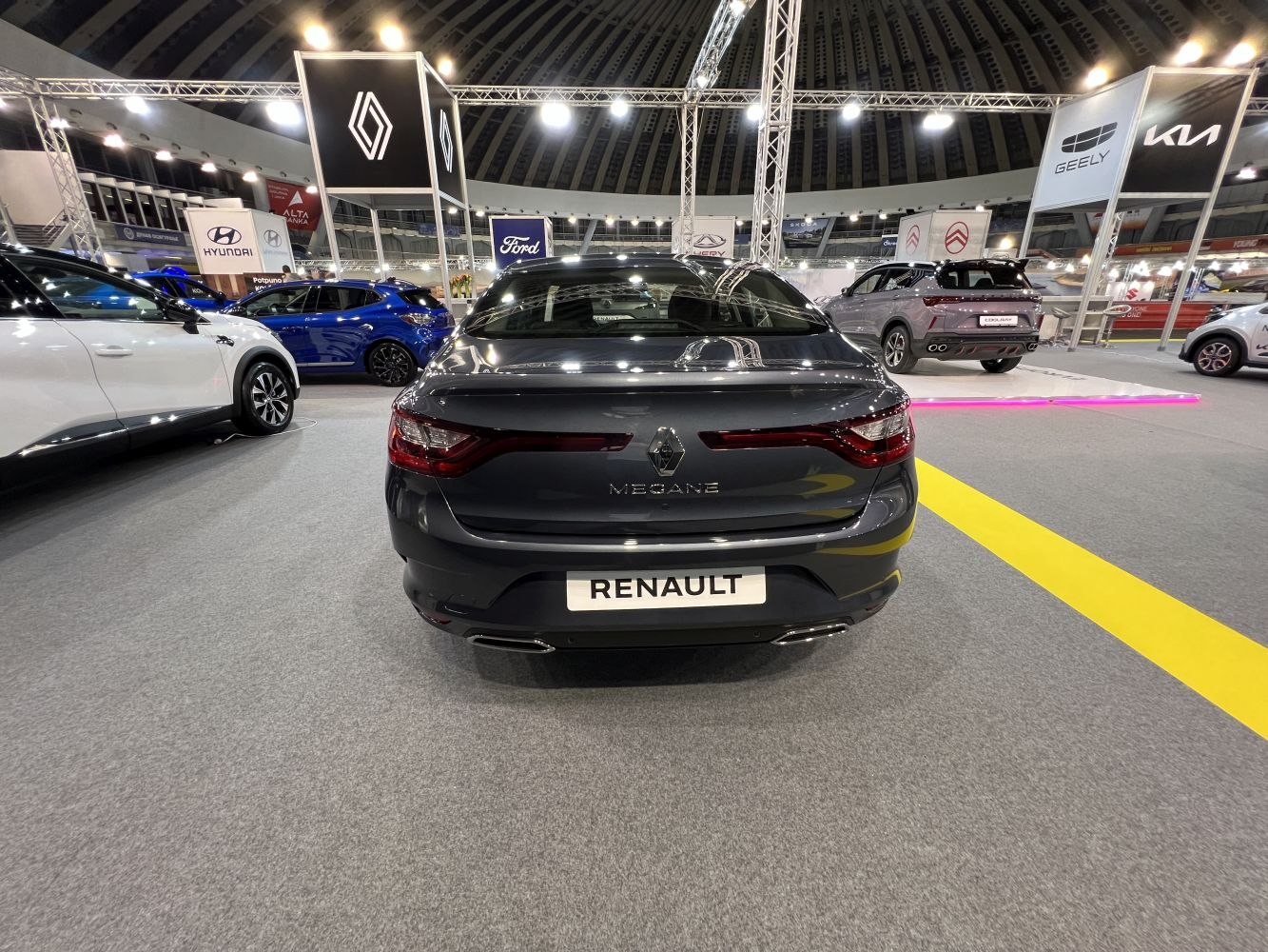 Rear view of a modern sedan with sleek taillights and dual exhaust pipes