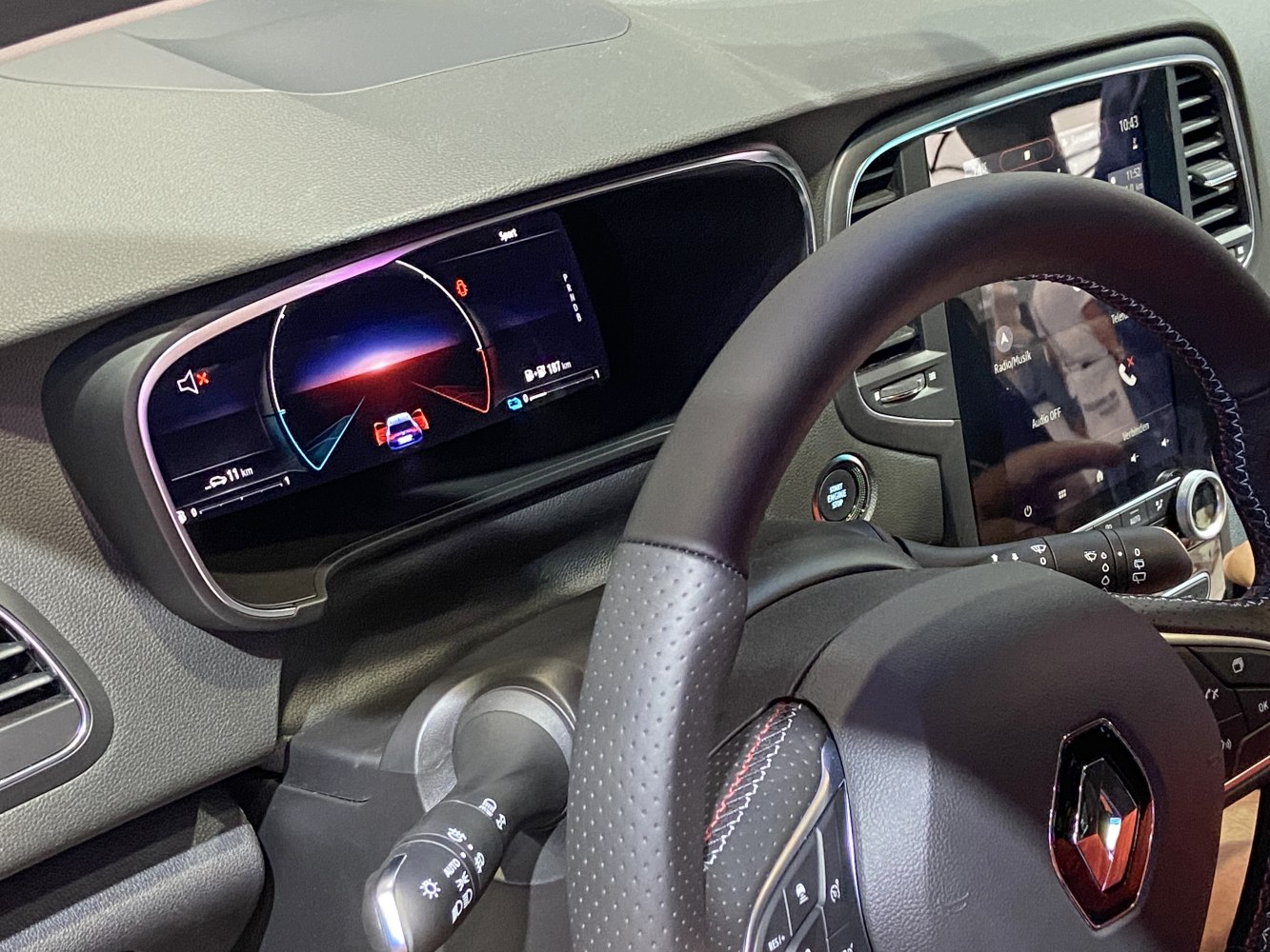 Digital instrument cluster and infotainment touchscreen in car interior