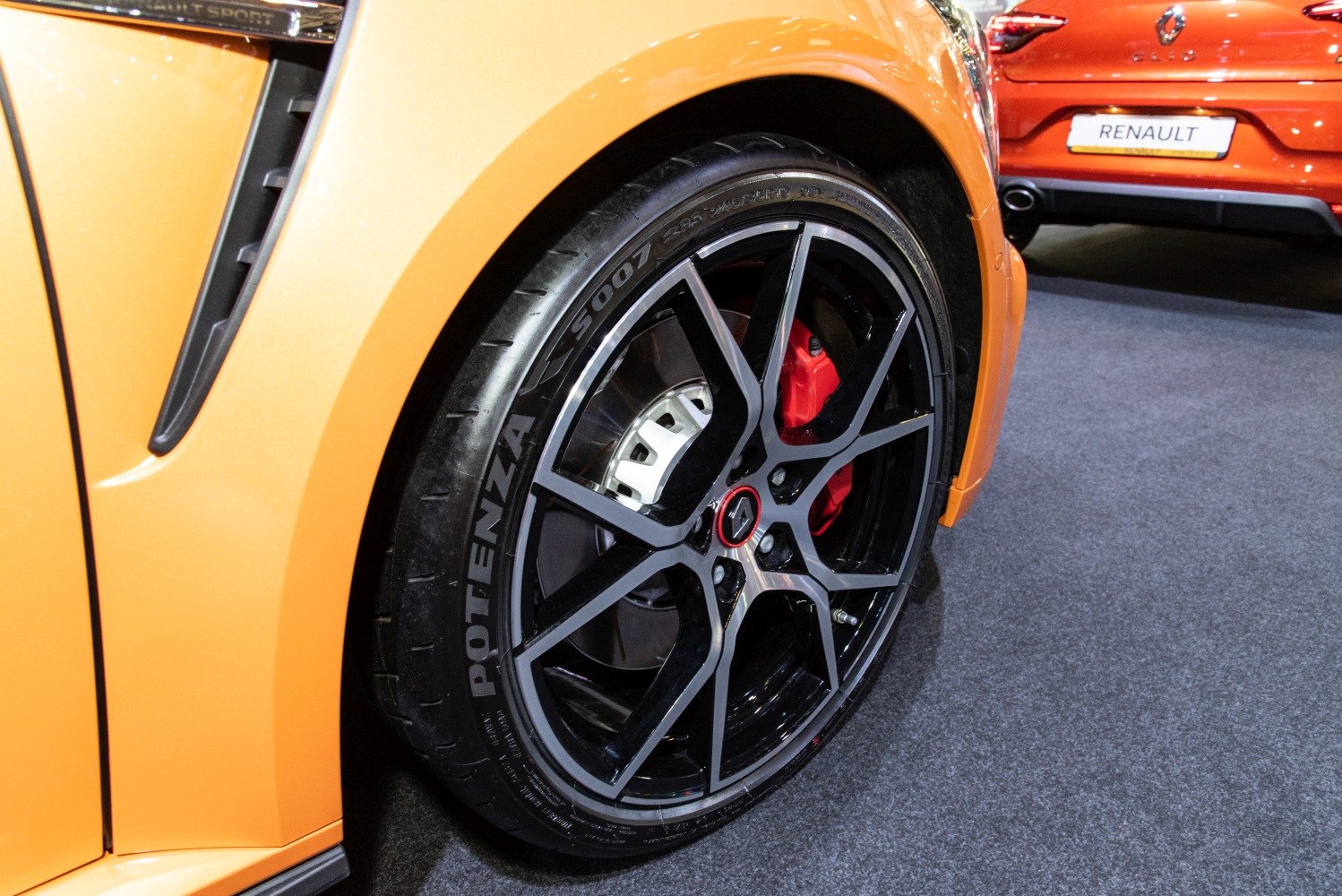 Sports alloy wheel and red brake caliper with side vent