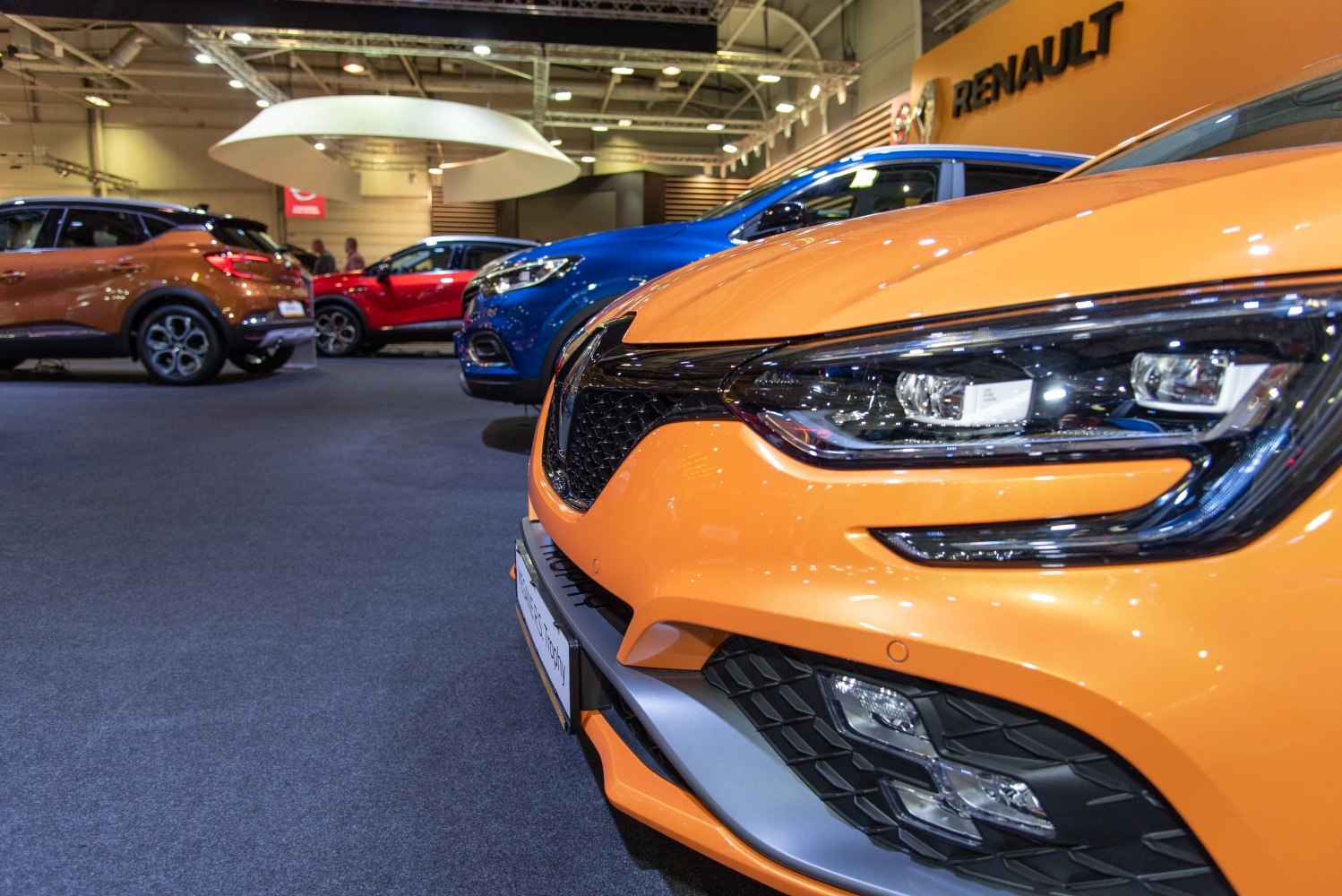 Close-up of illuminated LED headlight and honeycomb front grille