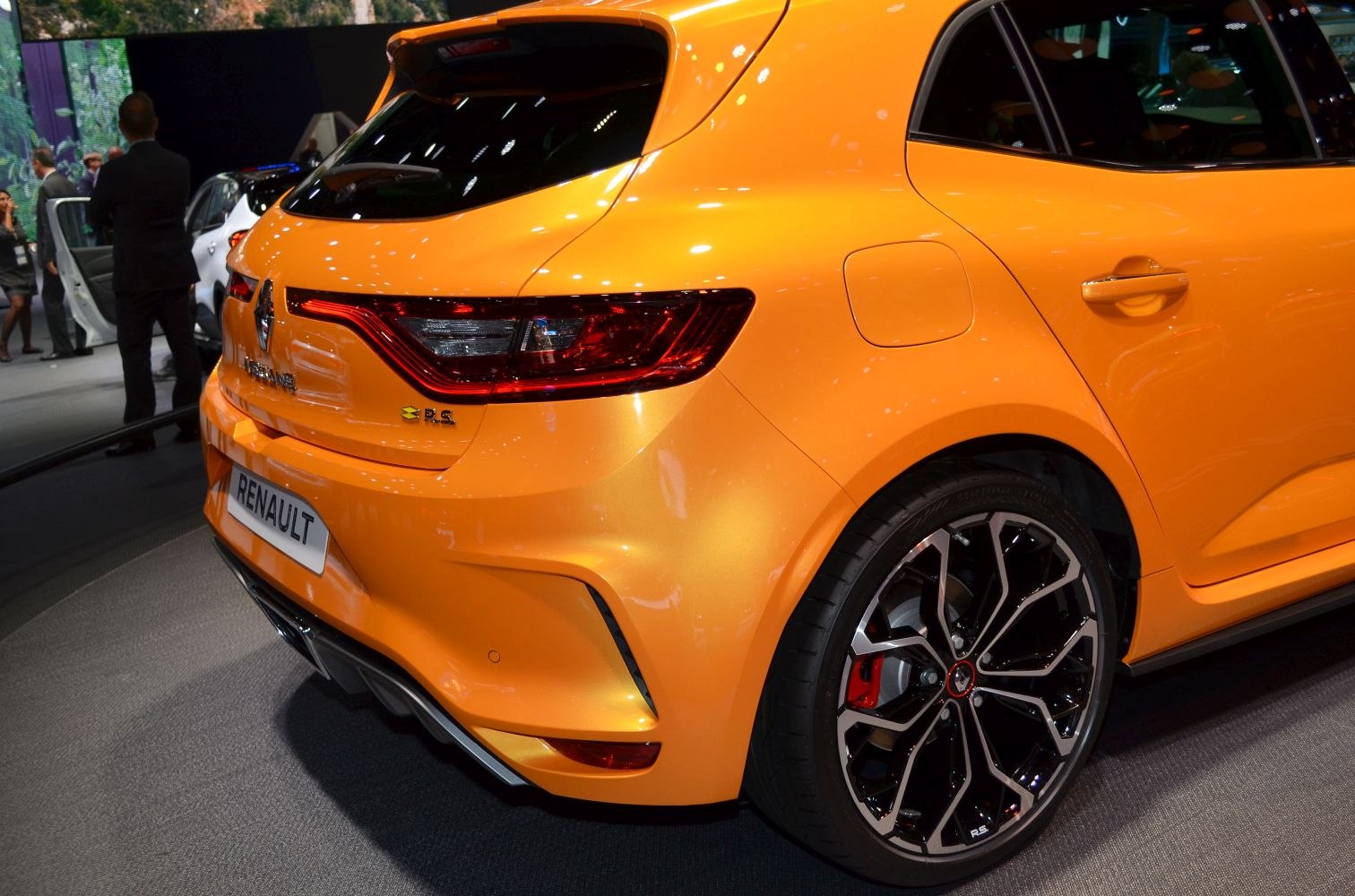Rear taillights and alloy wheel close-up on orange hatchback