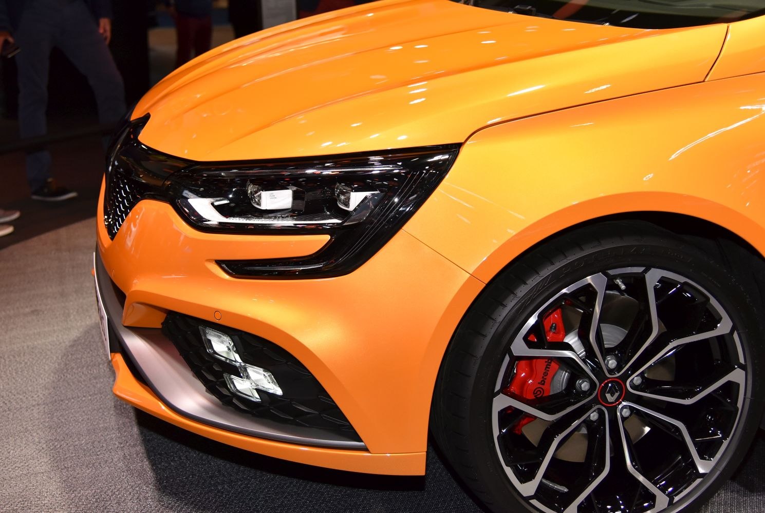 Front headlight and alloy wheel with red Brembo brake caliper