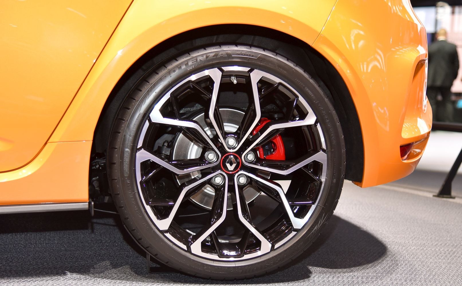 Alloy wheel with red brake caliper and disc brake system.
