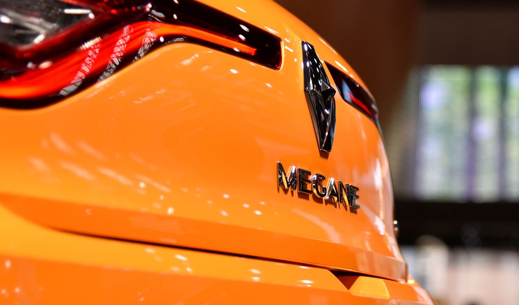 Rear badge and LED tail light of bright orange vehicle