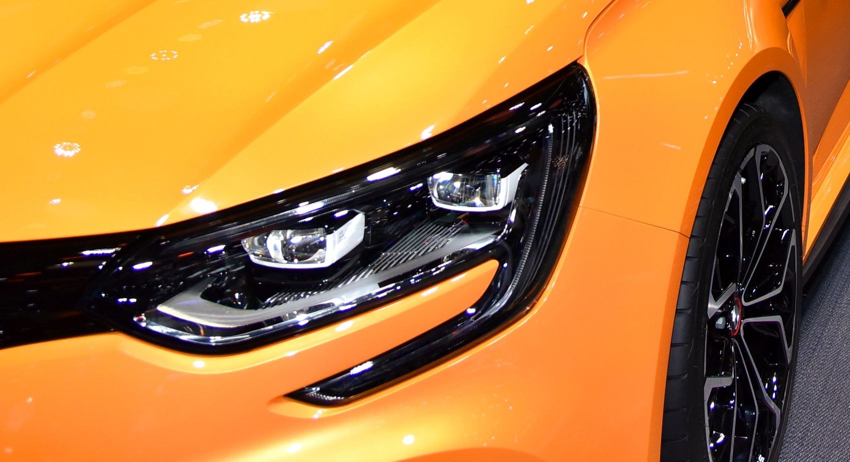 Sleek headlight and modern alloy wheel in close-up