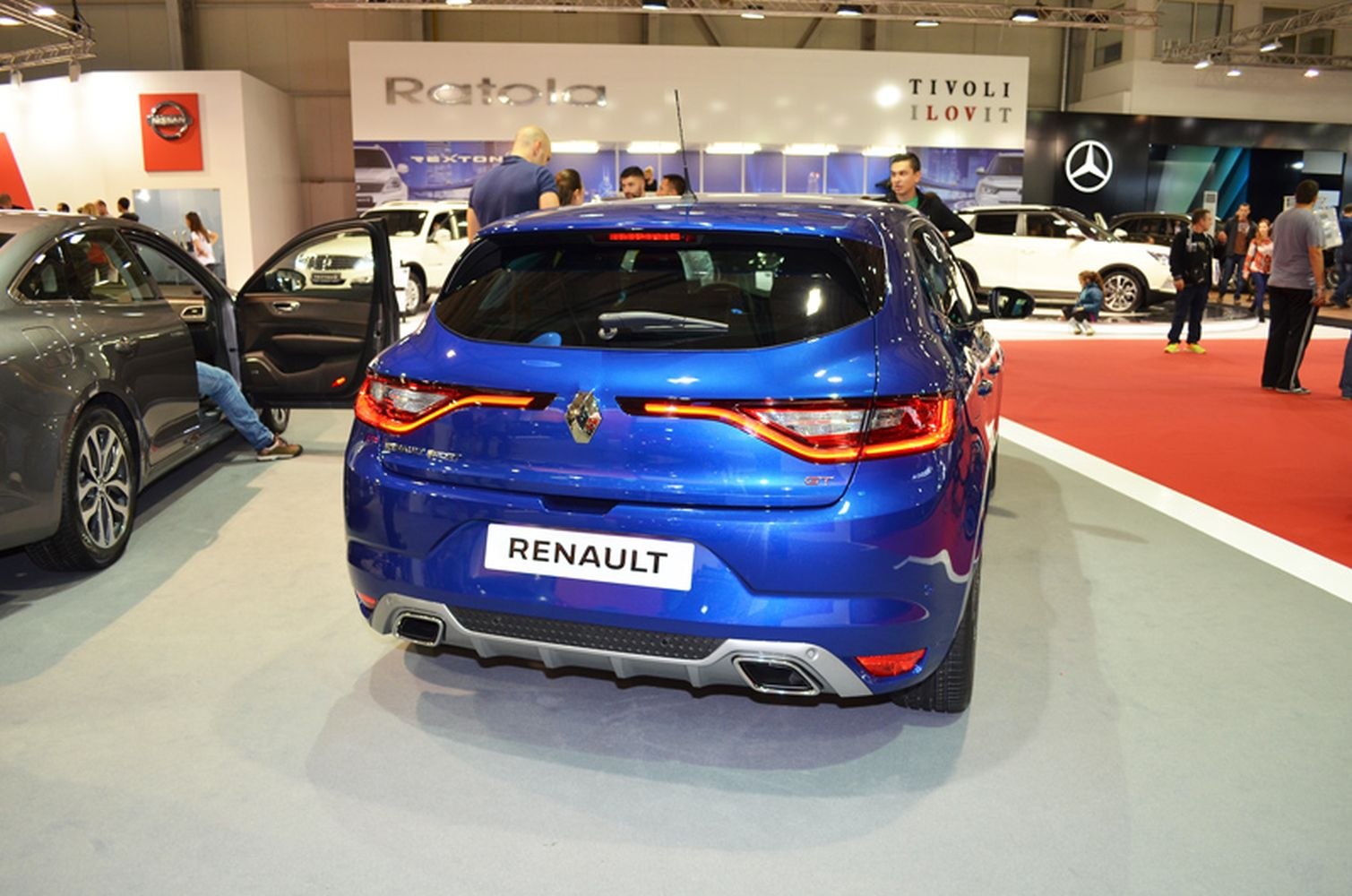 Rear view of blue hatchback with LED tail lights and dual exhausts
