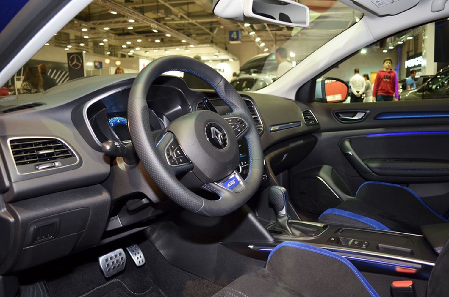 Sporty steering wheel and blue-accented modern car interior