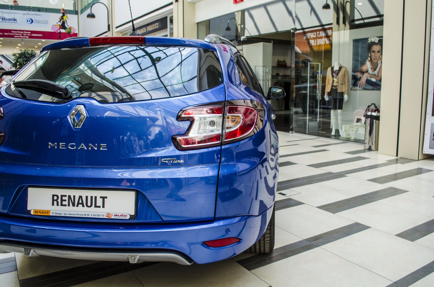 Rear view of blue hatchback with distinctive tail lights and GT Line badge