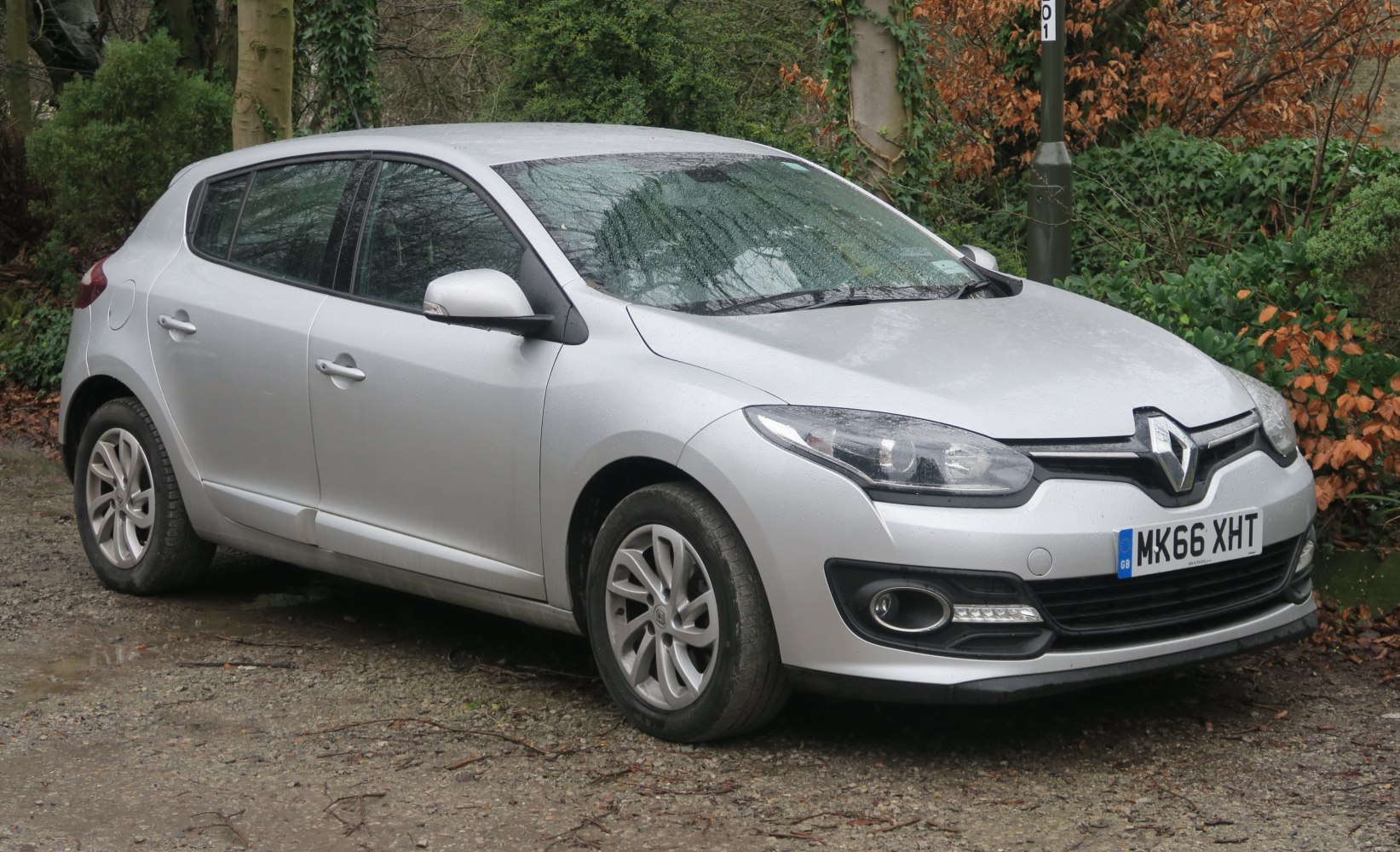 Silver hatchback with sleek headlights and alloy wheels