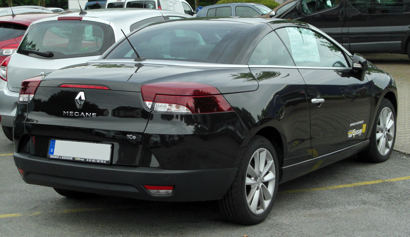 Rear and side view of a sleek black coupe with alloy wheels
