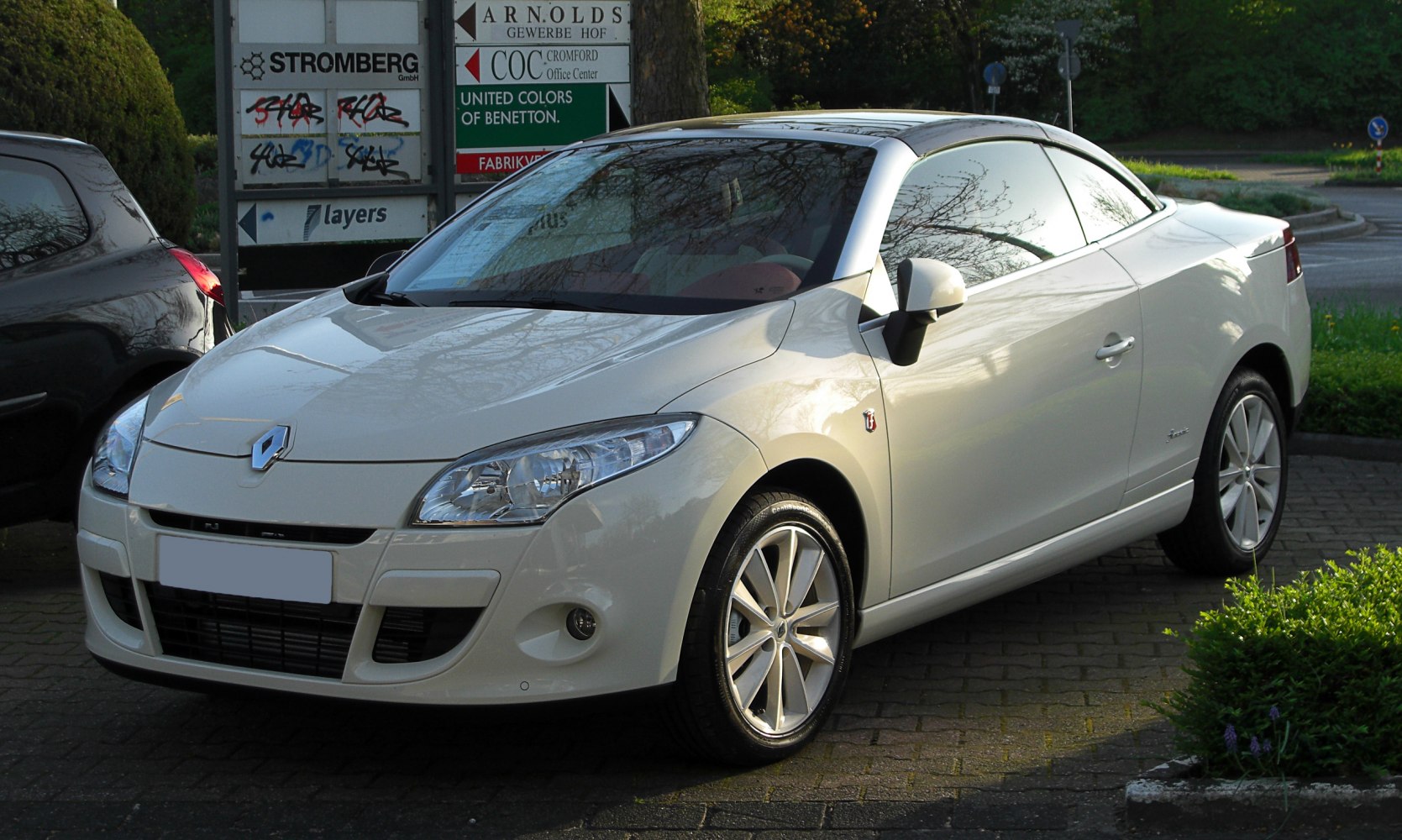 White convertible with sleek front grille and alloy wheels