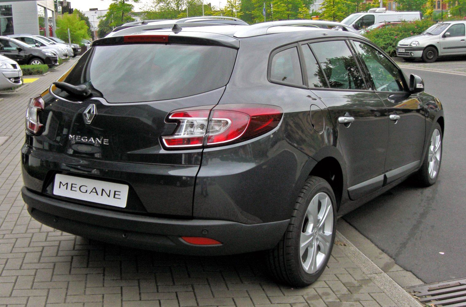 Rear view of a sleek hatchback with distinctive taillights and alloy wheels