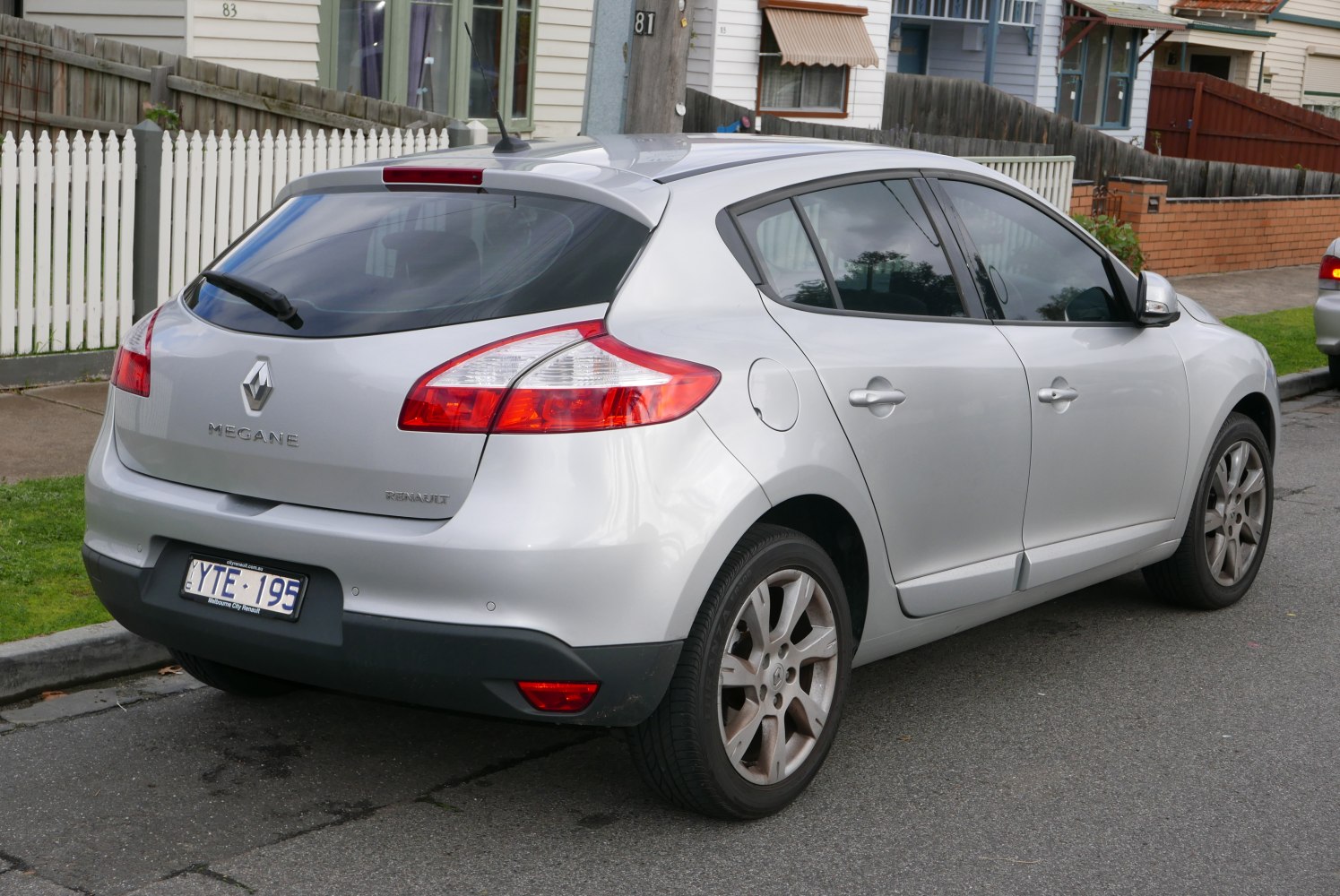Silver hatchback rear with distinct taillights and roof spoiler
