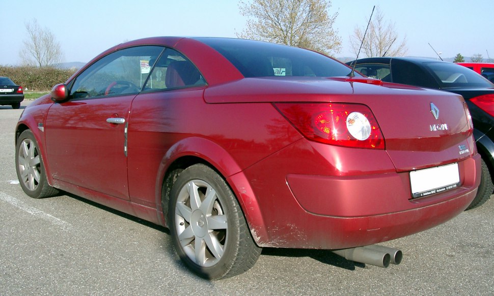 Red convertible showing rear side with dual exhaust and alloy wheels