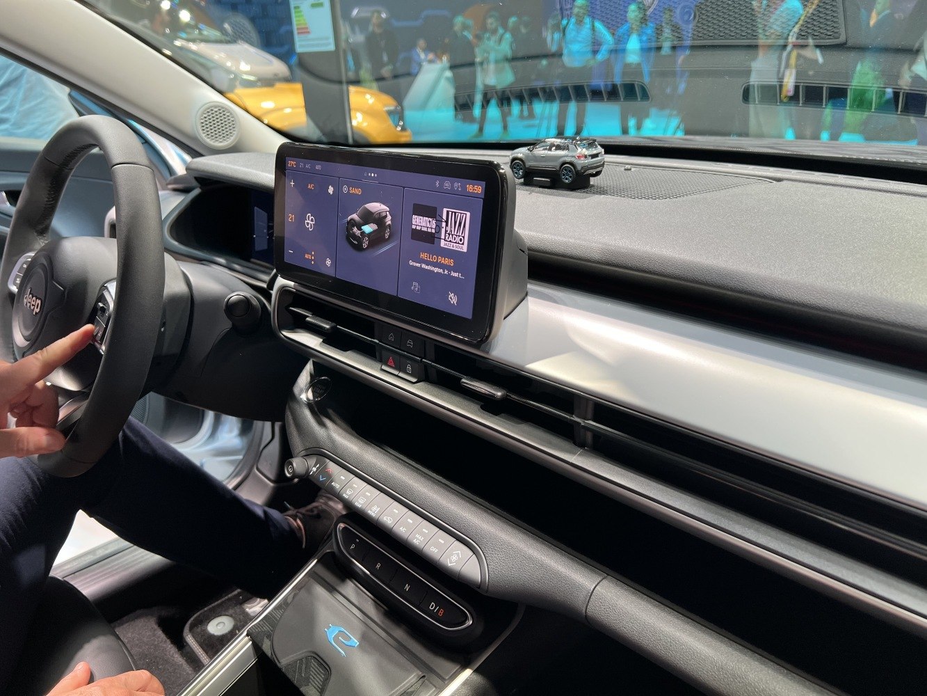 Digital infotainment screen and dashboard climate controls in a modern vehicle interior.