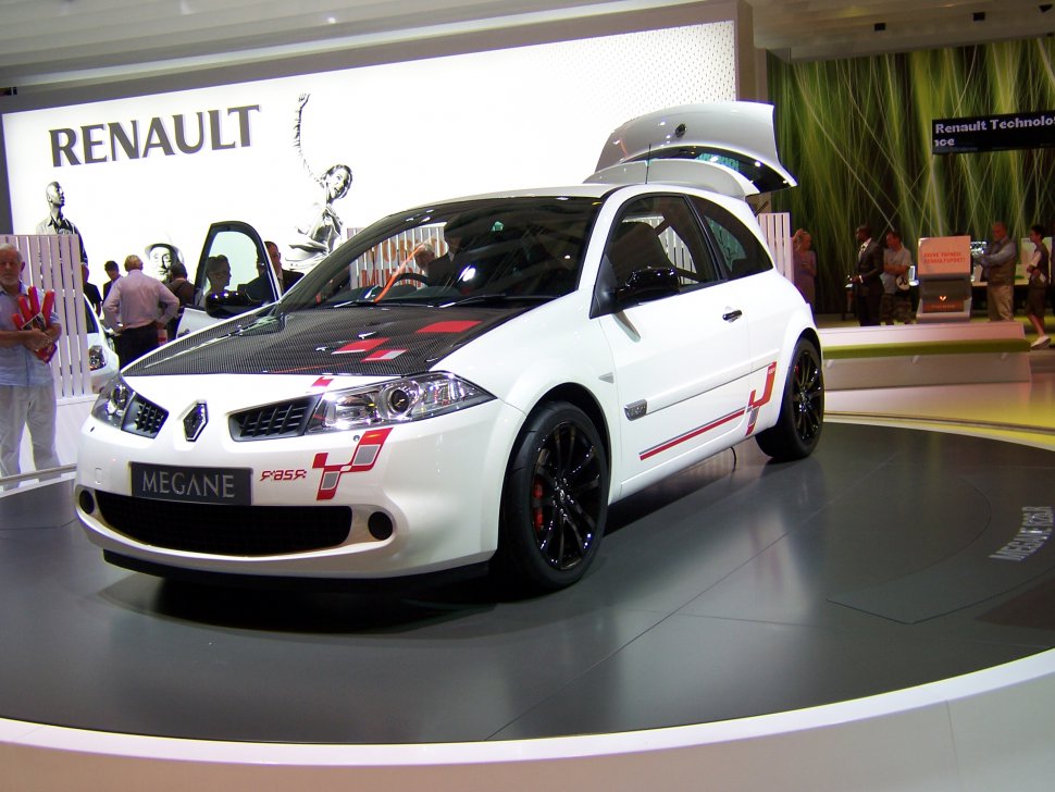 White coupe with black carbon hood, black sporty wheels, and red racing decals
