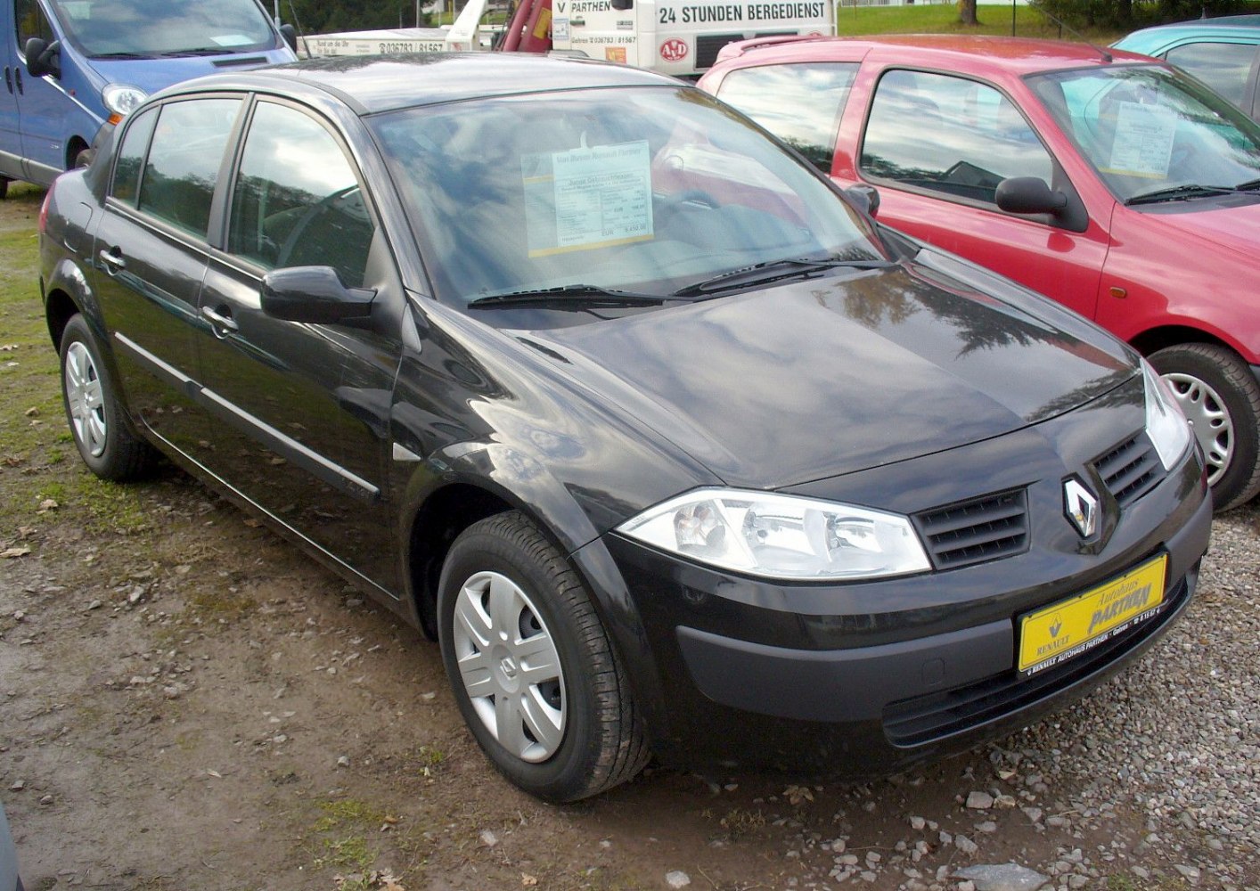 Black four-door sedan with sharp headlights and alloy wheels.