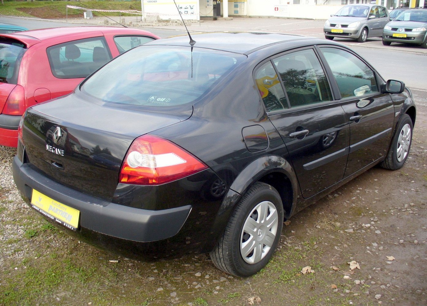 Rear-side view of black four-door sedan with distinctive taillights
