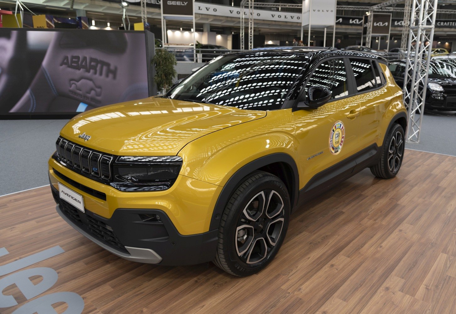 Yellow SUV front side view with distinctive grille and alloy wheels