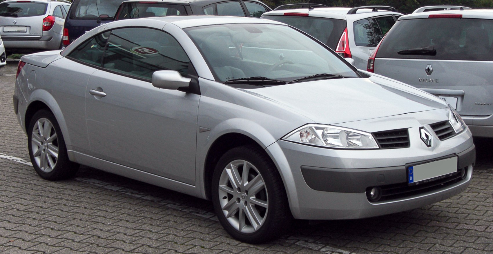 Silver two-door coupe with sporty design and alloy wheels.