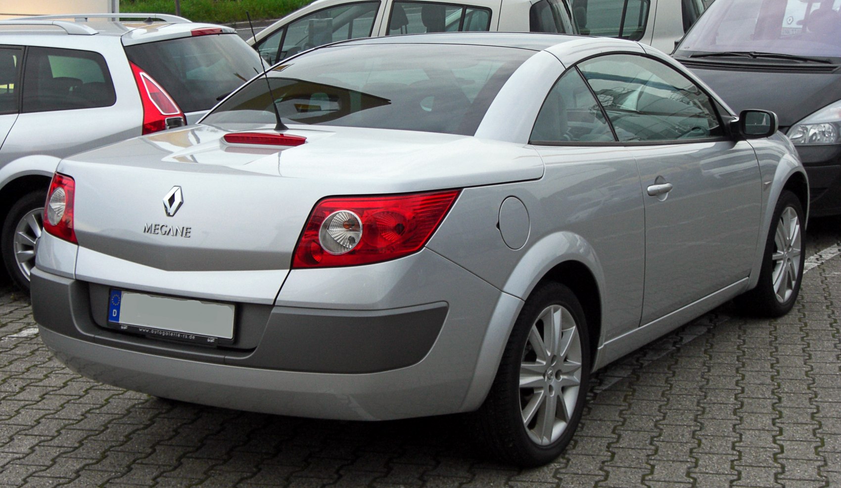 Rear and side view of a 2003 silver convertible with distinct taillights