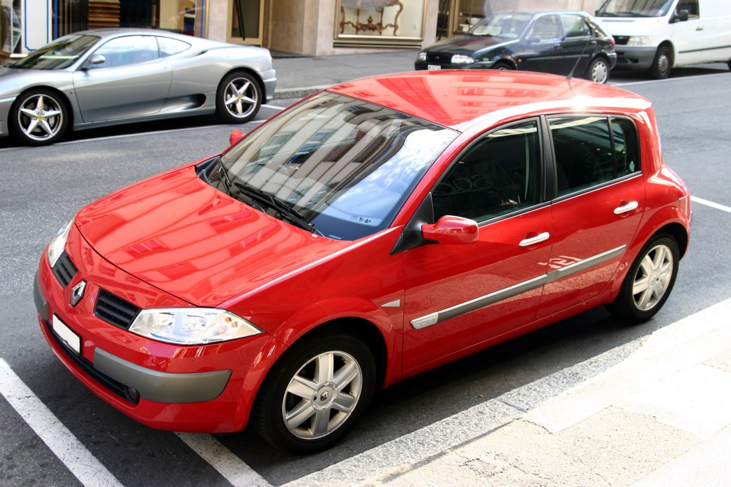 Red 5-door hatchback with silver alloy wheels and integrated mirrors