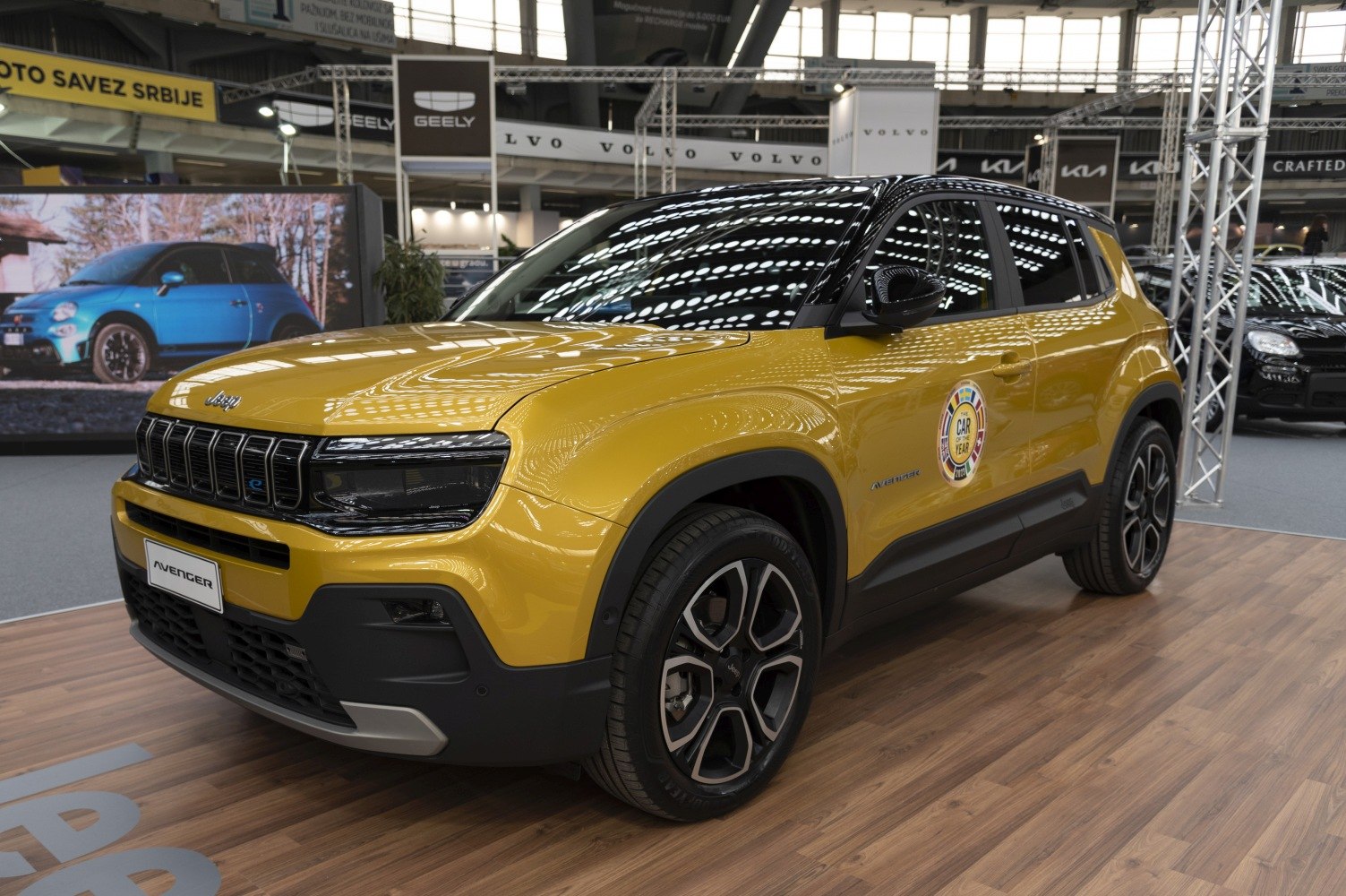 Front-side yellow SUV with bold grille and alloy wheels