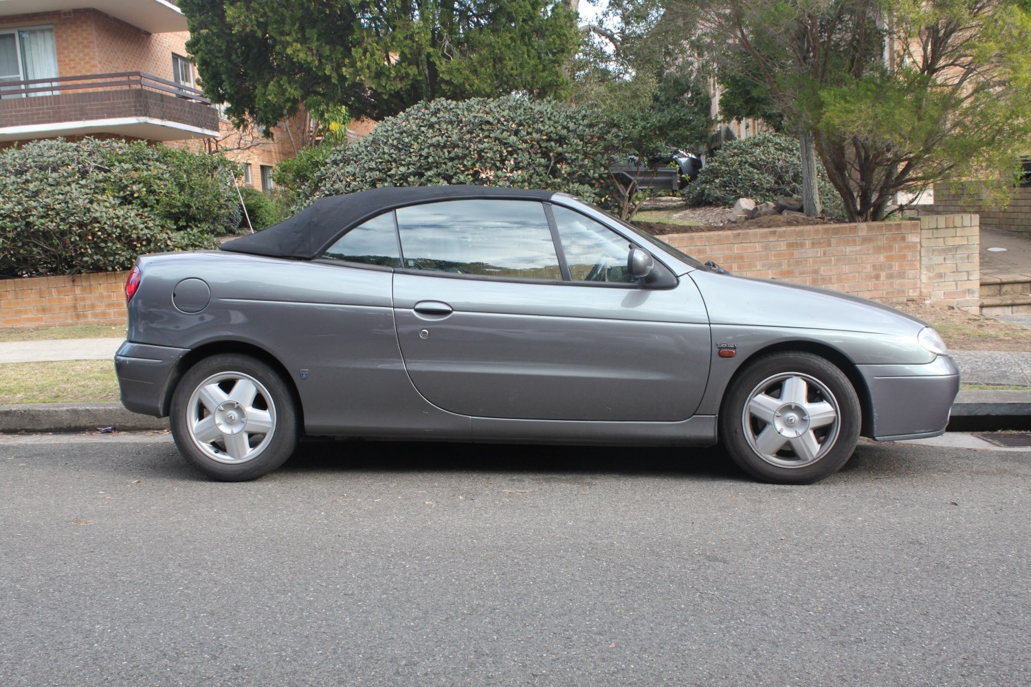 Soft top convertible shown from side with alloy wheels