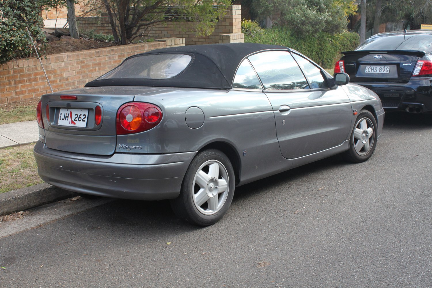 Rear view of a convertible with soft fabric roof and rounded tail lights