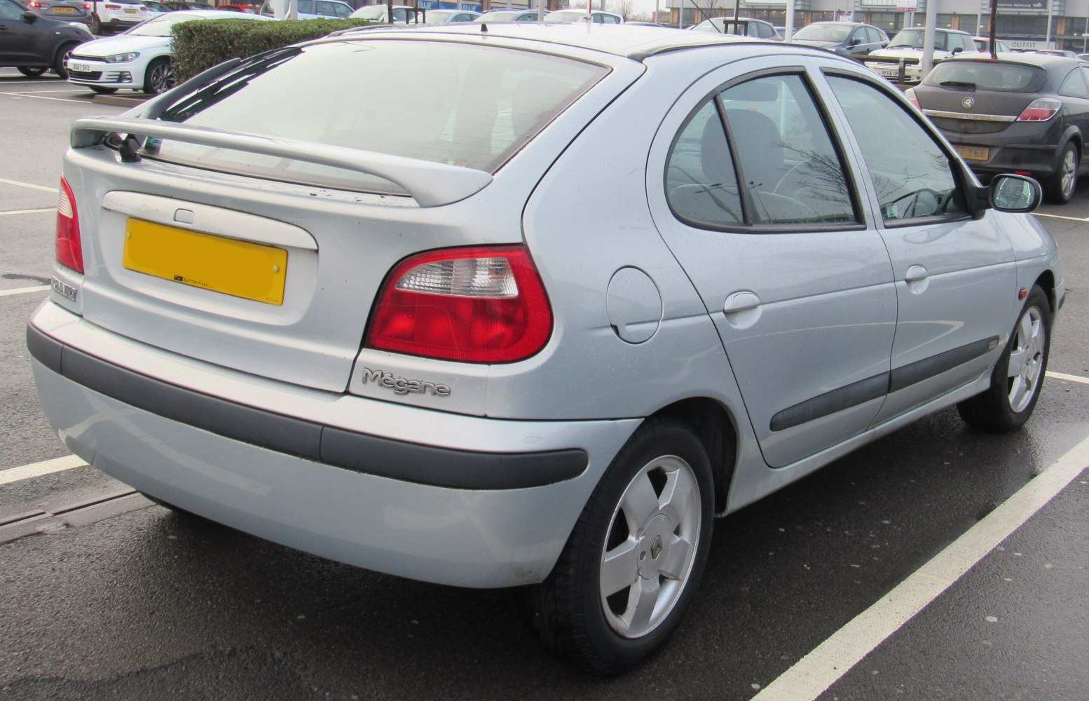 Rear and side view of hatchback with spoiler and distinctive taillights