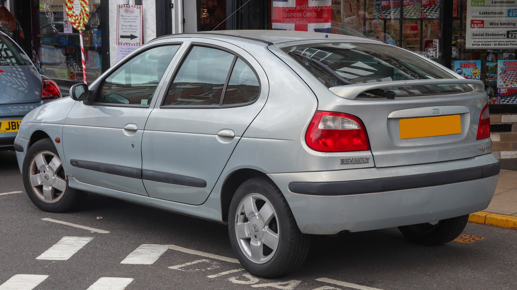 Silver hatchback rear side with tail lights and rear spoiler