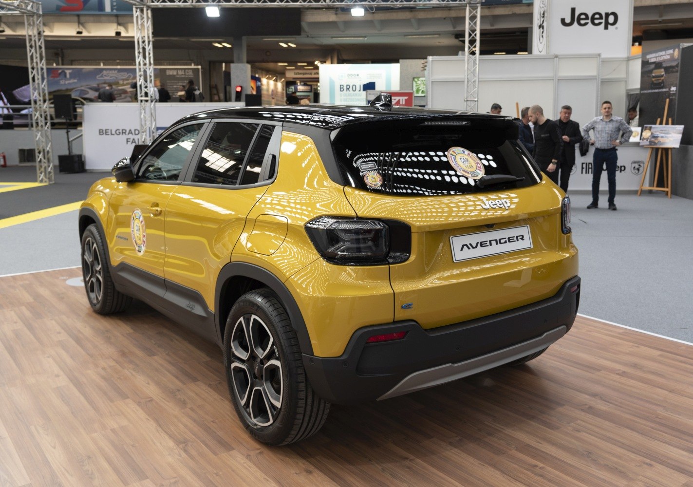Rear and side view of a yellow and black SUV with distinctive wheels and tail lights