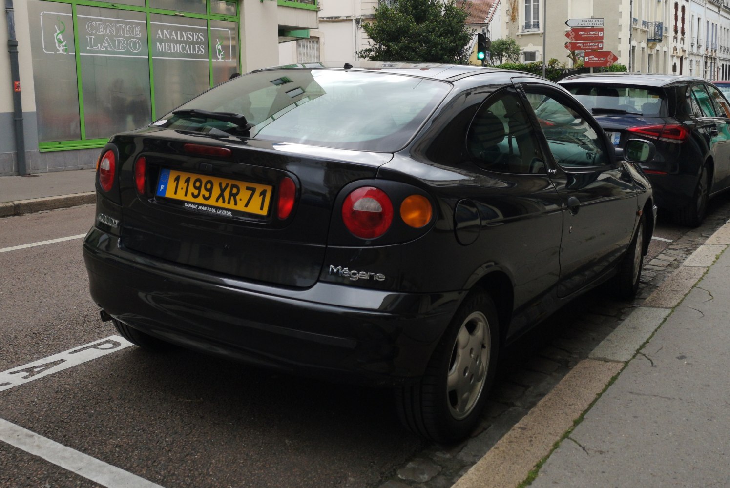 Rear view with round tail lights and hatchback design